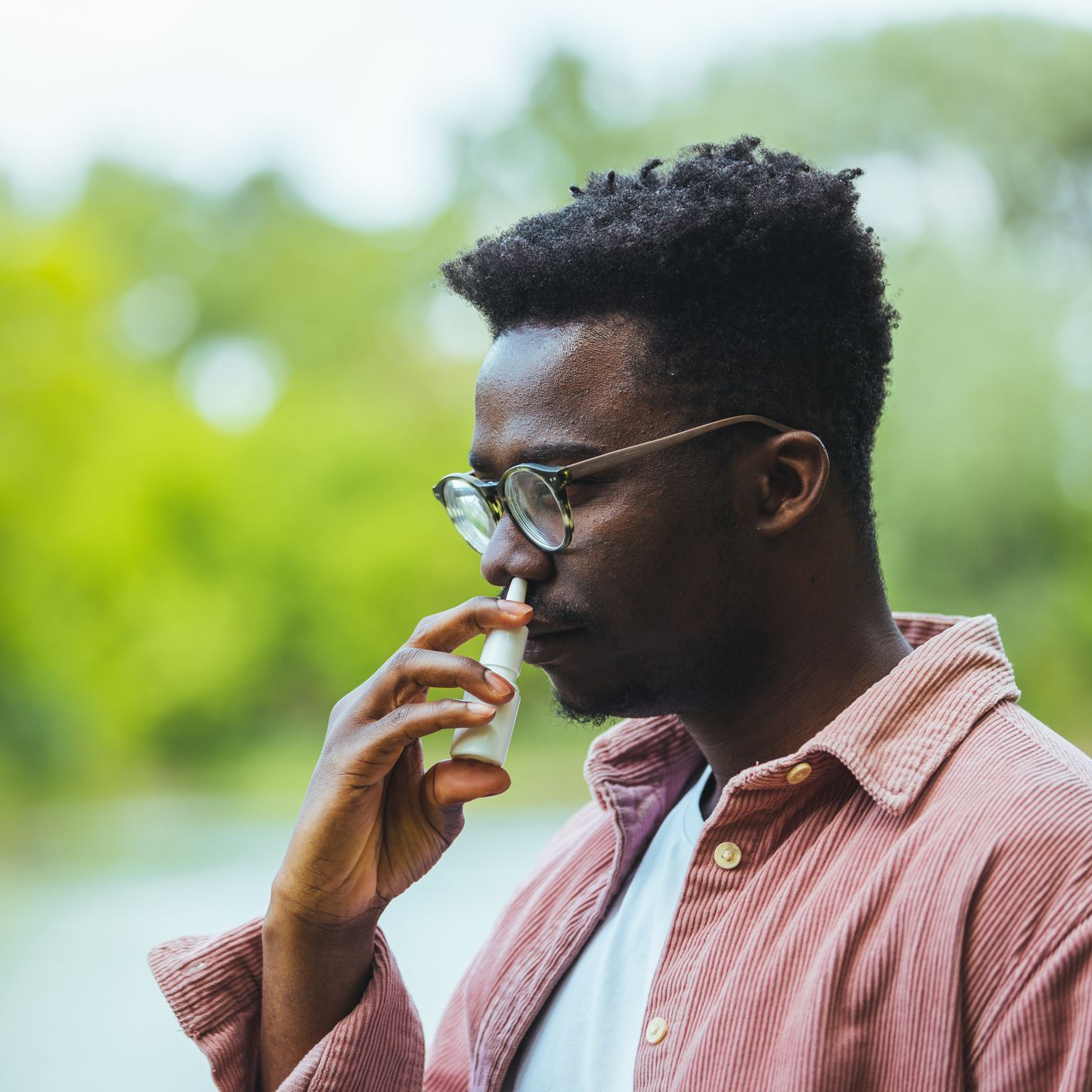 man using nasal spray